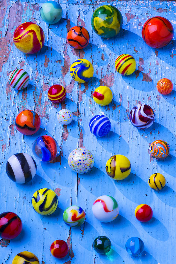 Toy Photograph - Marbles on blue board by Garry Gay