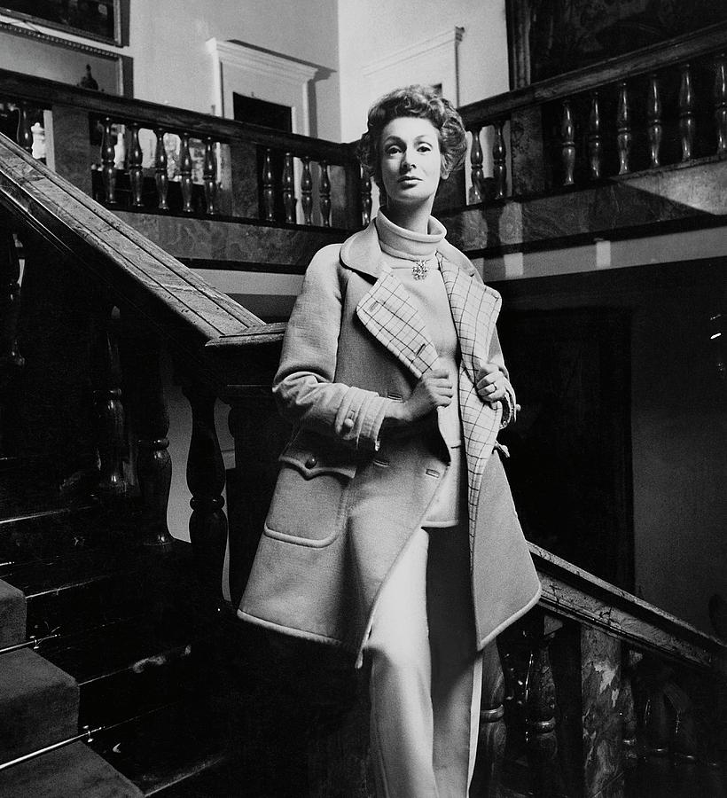 Marella Agnelli Wearing A Courreges Raincoat Photograph by Henry Clarke