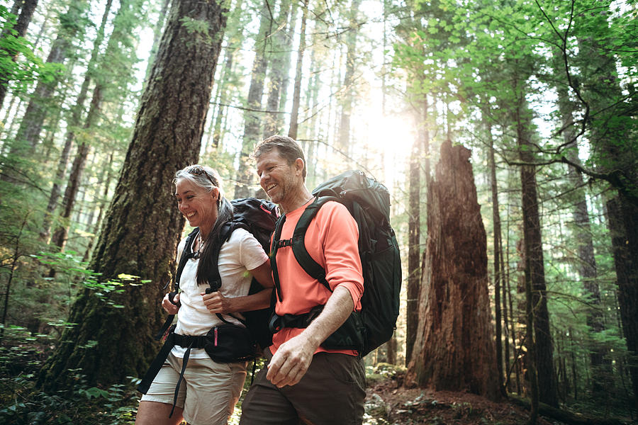 Mature Couple Backpacking in Forest Photograph by RyanJLane