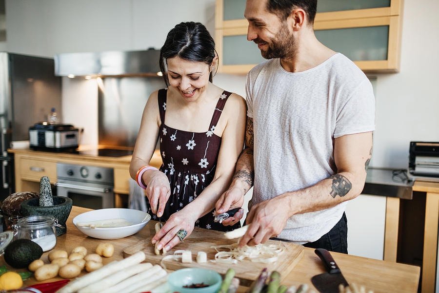 Mature couple preparing food for dinner Photograph by Hinterhaus Productions