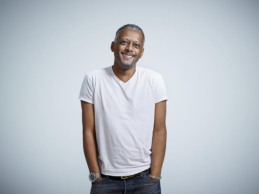 Mature male smiling with hands in pockets Photograph by Mike Harrington