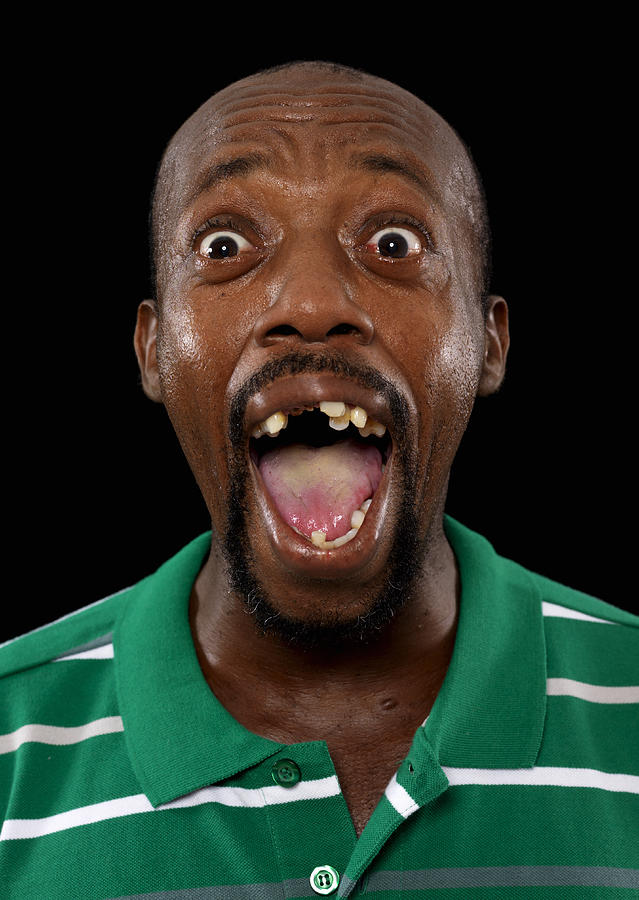 Mature man screaming, mouth open, close-up Photograph by Bob Thomas
