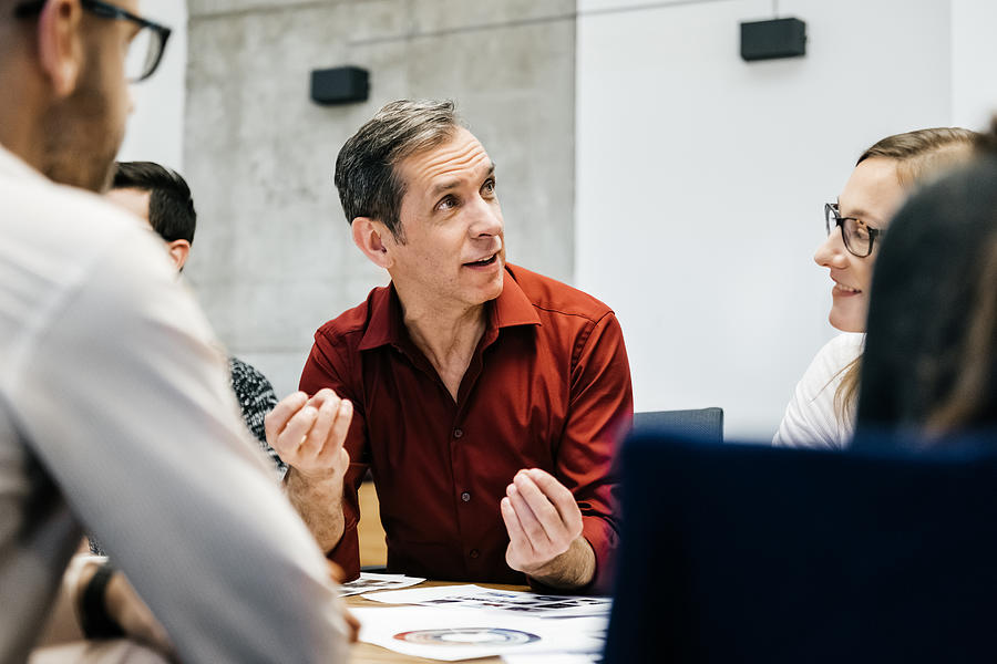 MAture man speaking in a business meeting. Photograph by Hinterhaus Productions MAture man speaking in a business meeting. Photograph by Hinterhaus Productions