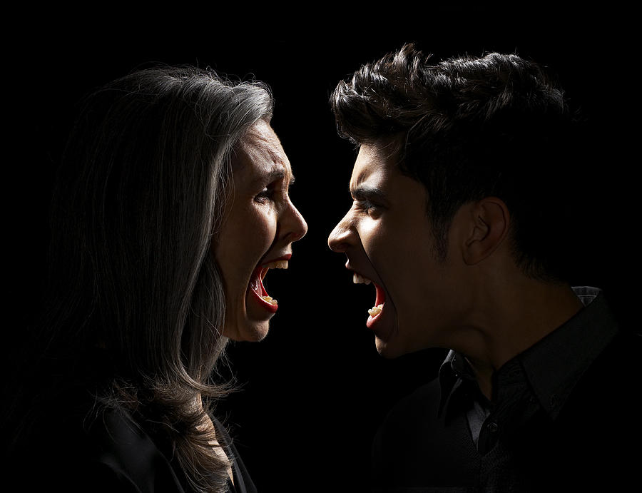 Mature Woman and Teen Boy Yelling Photograph by Thomas Northcut