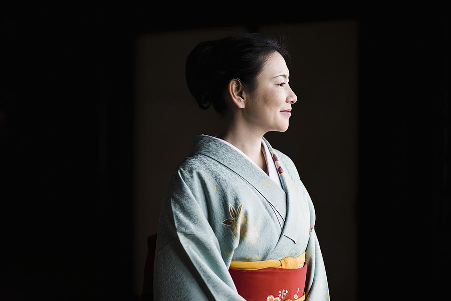 Mature woman in a kimono at a temple Photograph by Yagi-Studio