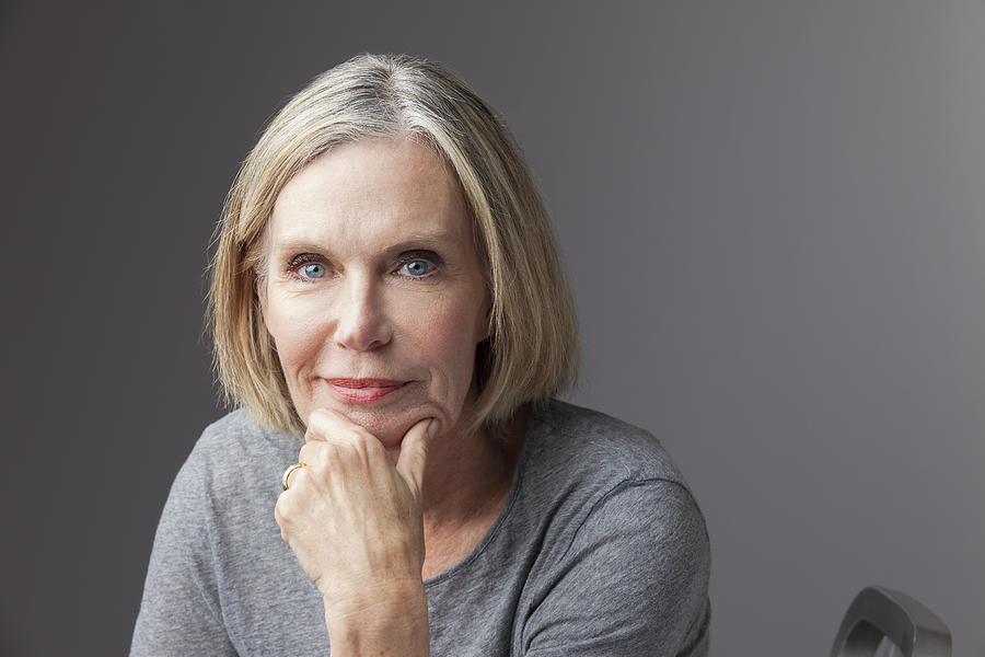 Mature woman with hand on chin, portrait Photograph by Tripod
