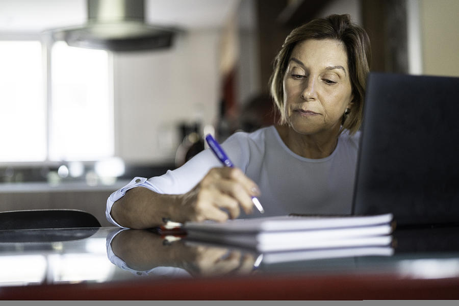 Mature woman working at home Photograph by FG Trade