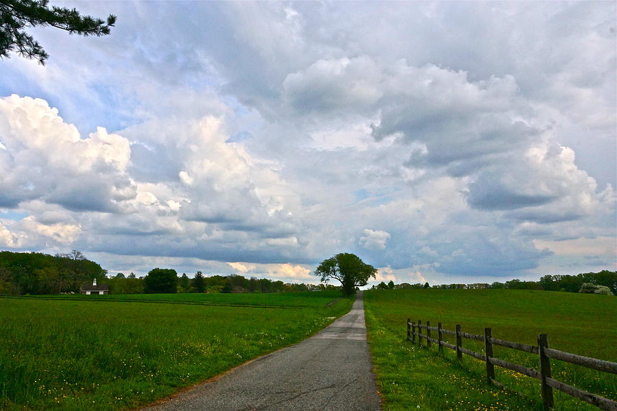 May Storm Clouds and a Patch of Blue over the Farm Photograph by Byron Varvarigos