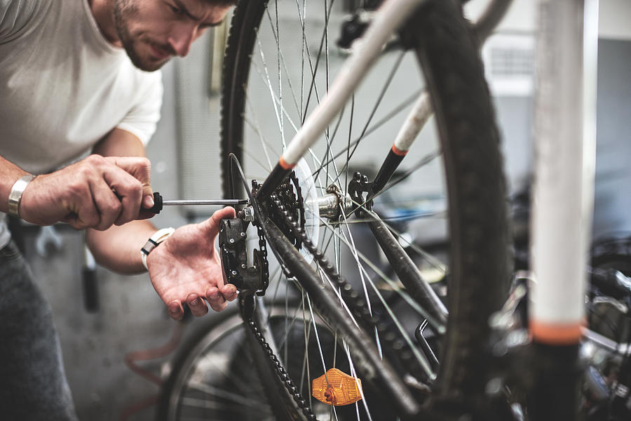 Mechanic repairing bicycle transmission Photograph by Predrag Vuckovic