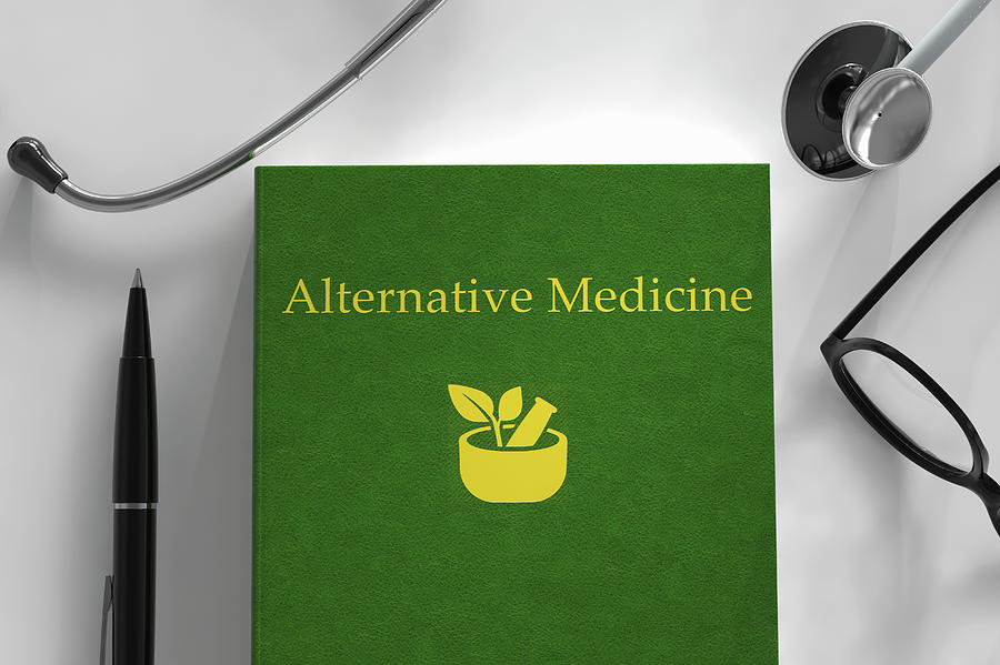 Medical Book About Alternative Medicine Photograph by Ikon Images