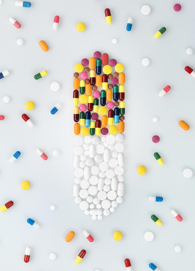Medical pills and tablets in shape of drug capsule and scattered Photograph by Andrew Brookes