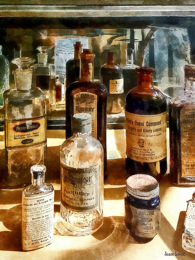 Medicine Bottles in Glass Case Photograph by Susan Savad