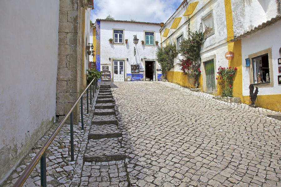 Medieval Cobblestone Street in the Fortified Walled European Village of Obidos Photograph by David Letts
