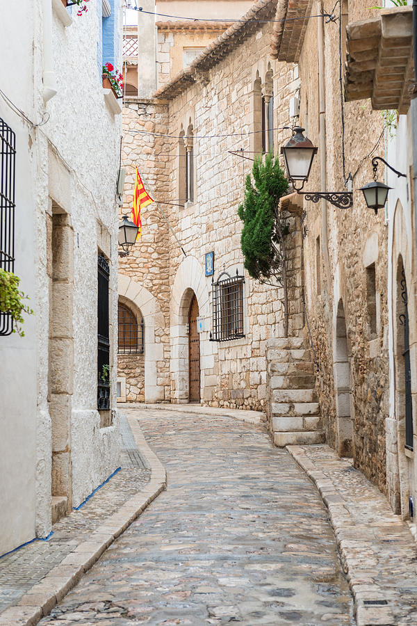 Medieval street in Sitges old town Spain Photograph by Marek Poplawski