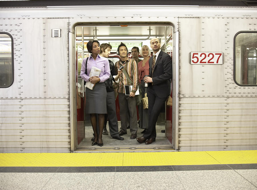 Medium group of people standing in subway train doorway Photograph by Darrin Klimek