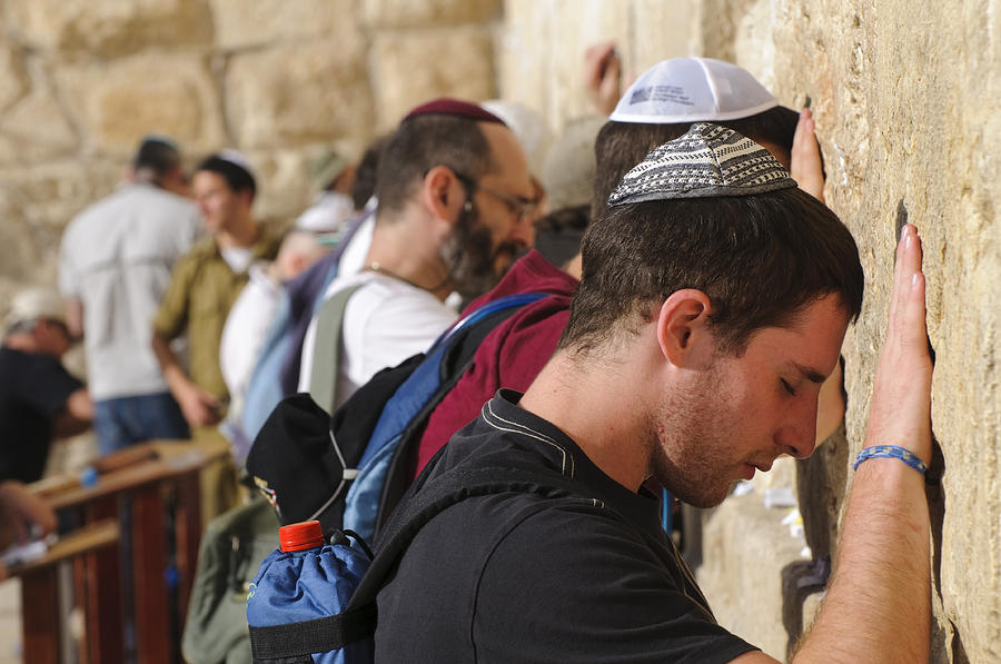 Men praying at Jerusalems Western Wall Photograph by Joel Carillet