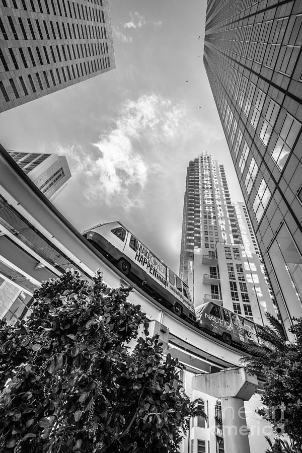 Black And White Photograph - Metromover working in downtown Miami - Black and White by Ian Monk