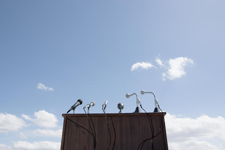 Microphones on lectern, outdoors, low angle view Photograph by Martin Barraud