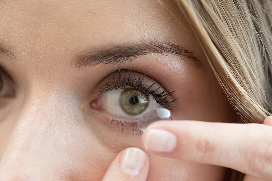 Mid Adult Woman Putting Contact Lens In Eye Photograph by Science Photo Library