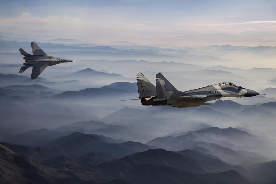 Mig-29 Fighter Jets in Flight above the fogy mountains Photograph by Guvendemir