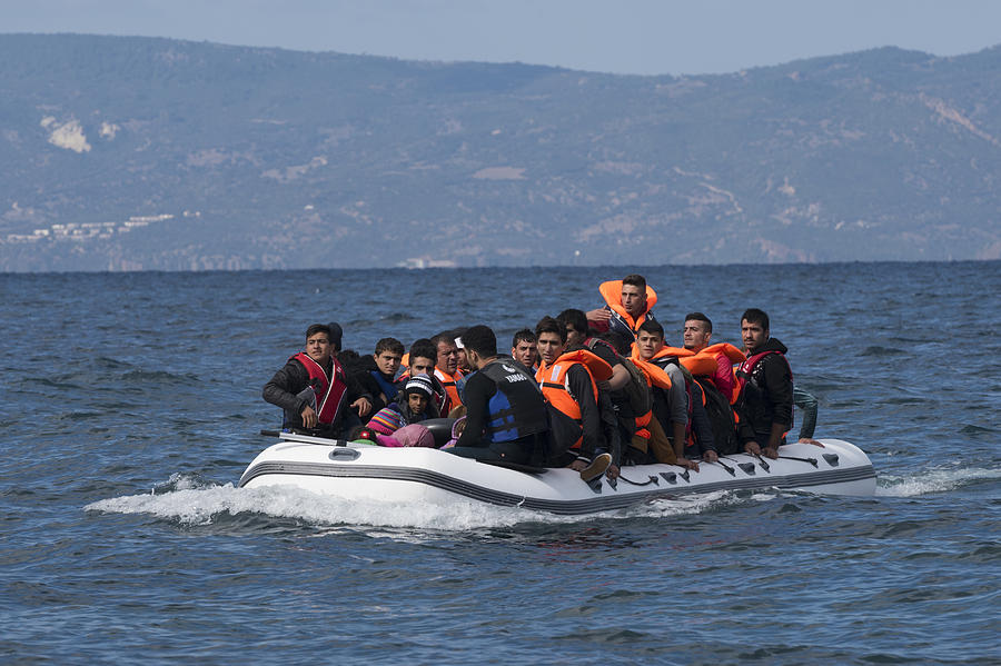 Migrants in inflatable boat between Greece and Turkey Photograph by Joel Carillet