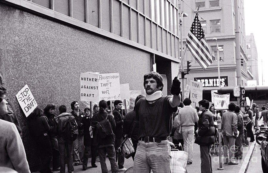 Military veteran  holding Flag at War Protest Photograph by Jim Corwin