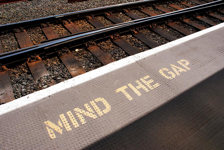 Mind The Gap Warning Sign At Rail Station Photograph by Mark Williamson/science Photo Library