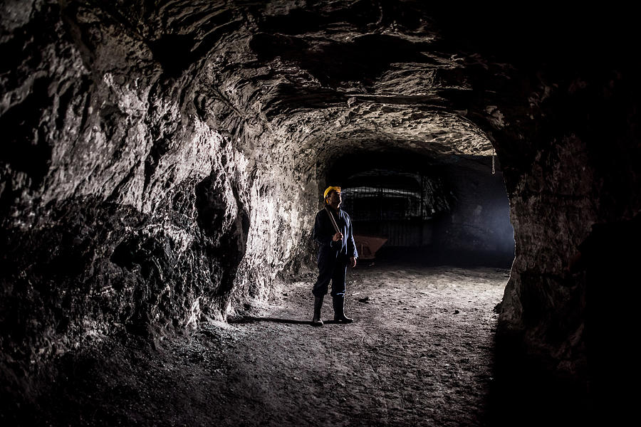 Miner working at a mine underground Photograph by Andresr
