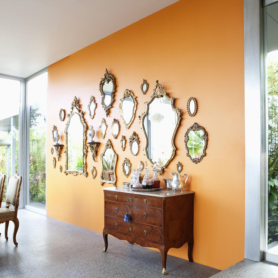 Mirrors on orange wall Photograph by Robert Nicholas