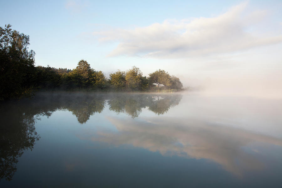 Mist Over A Tranquil Lake Photograph by John Doornkamp / Design Pics