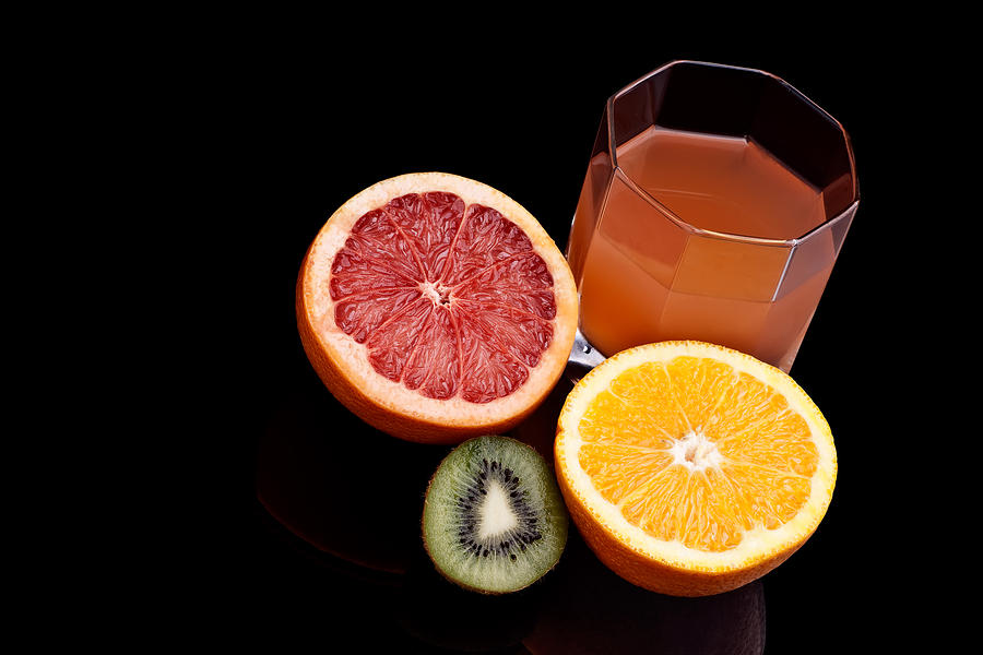 Mixed orange kiwi and grapefruit juice Photograph by Marek Poplawski