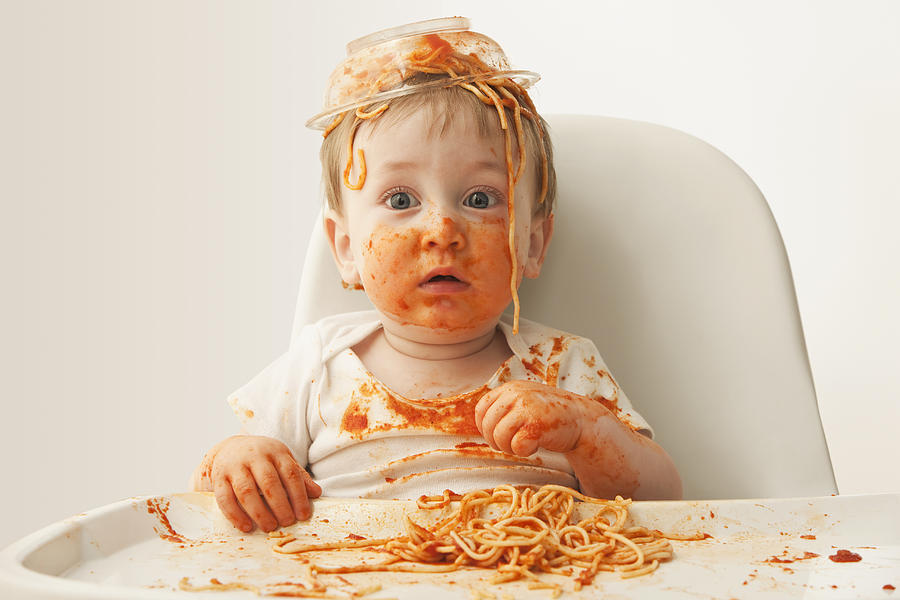 Mixed race baby boy eating spaghetti Photograph by Jose Luis Pelaez Inc
