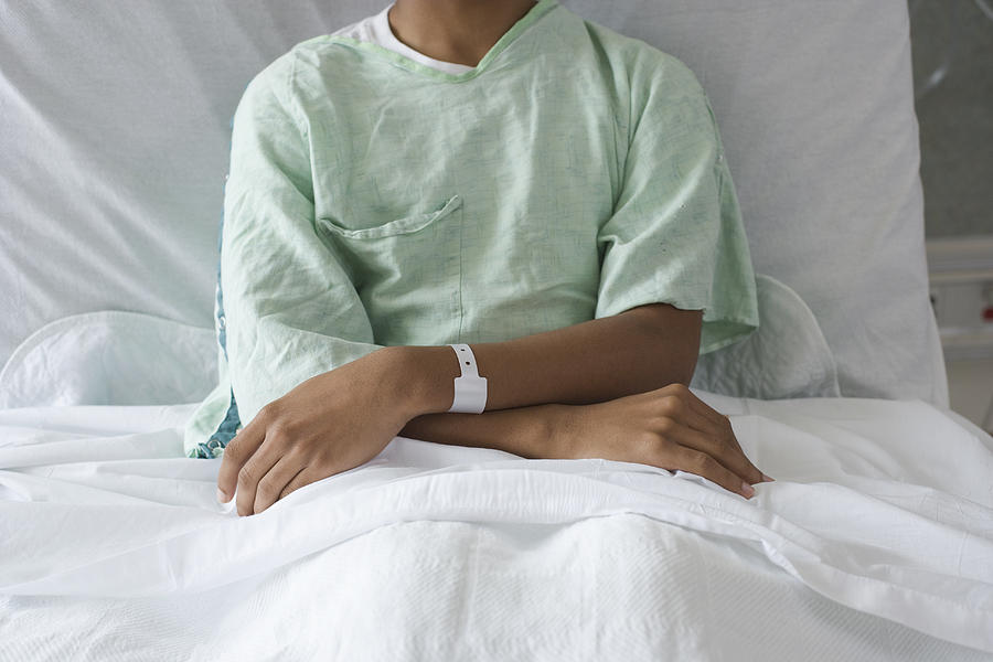 Mixed race boy in hospital bed Photograph by ER Productions Limited
