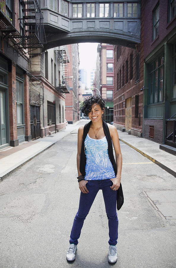 Mixed race woman standing on urban street Photograph by JGI/Jamie Grill