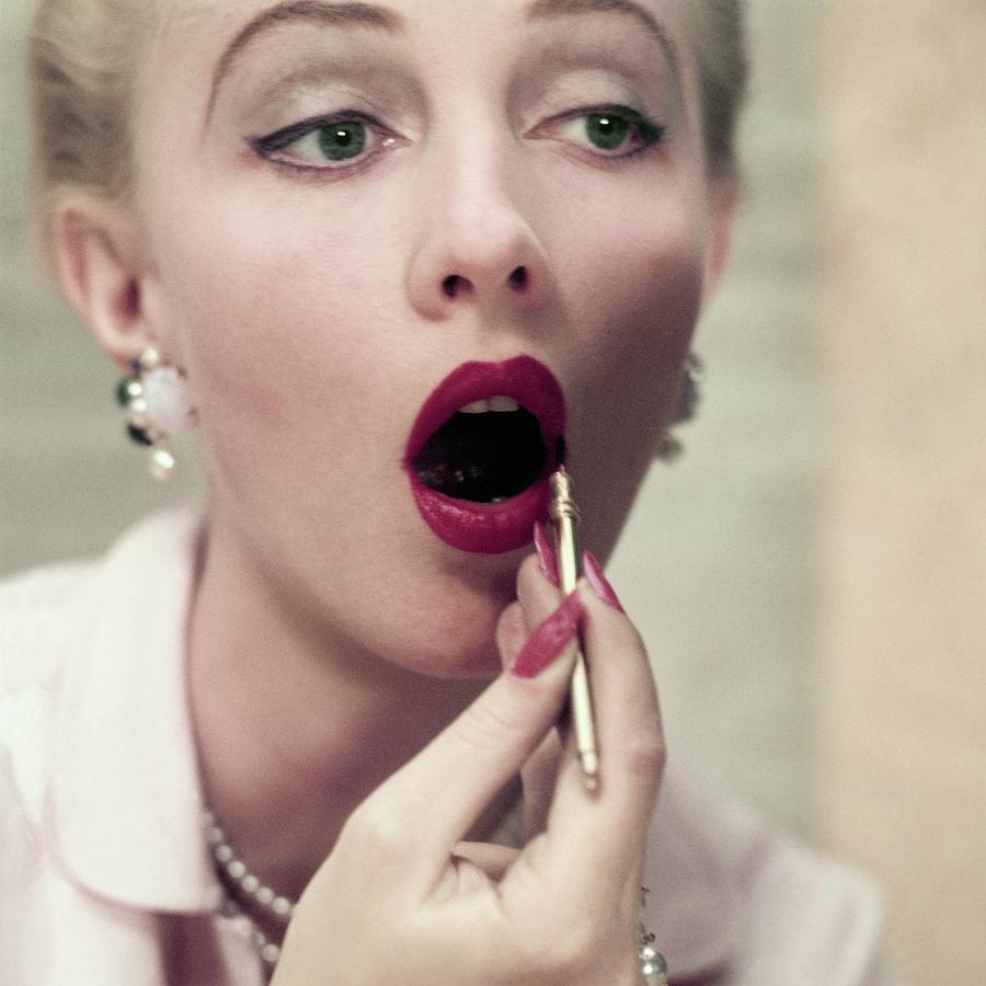Model Applying Revlon Lipstick Photograph by Frances McLaughlin-Gill