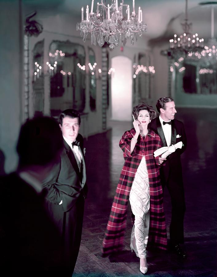 Model In Silver Dress Escorted By A Gentleman Photograph by Henry Clarke
