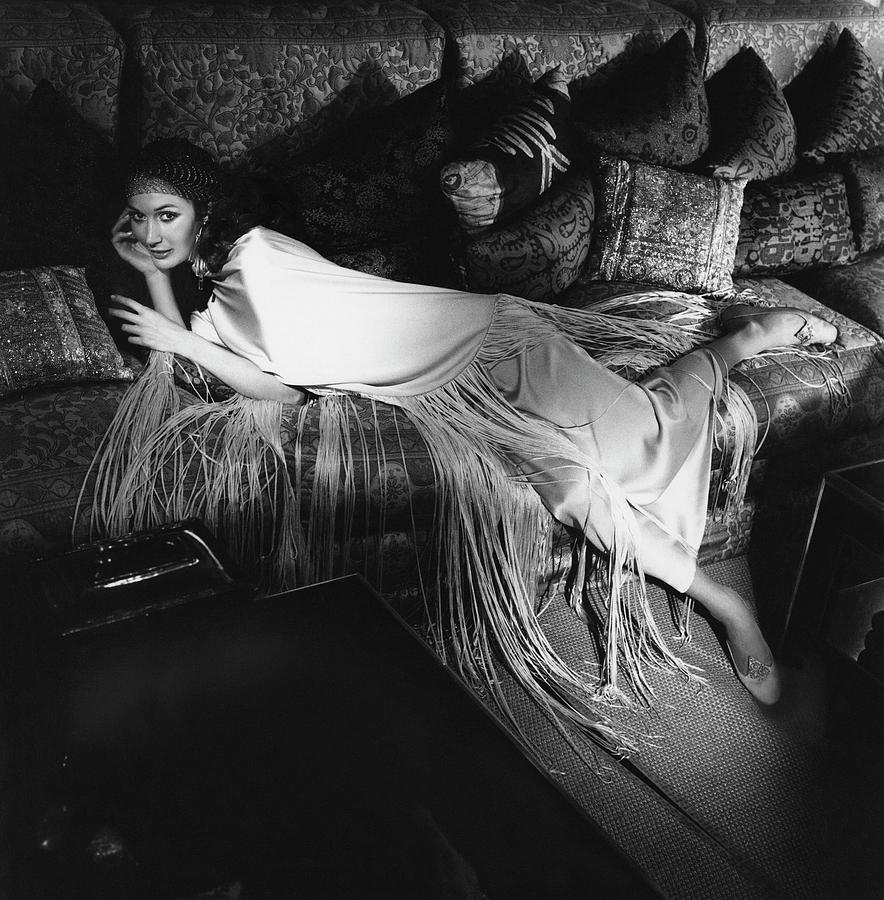 Model Lying On A Couch In A Antonelli Poncho Photograph by Henry Clarke