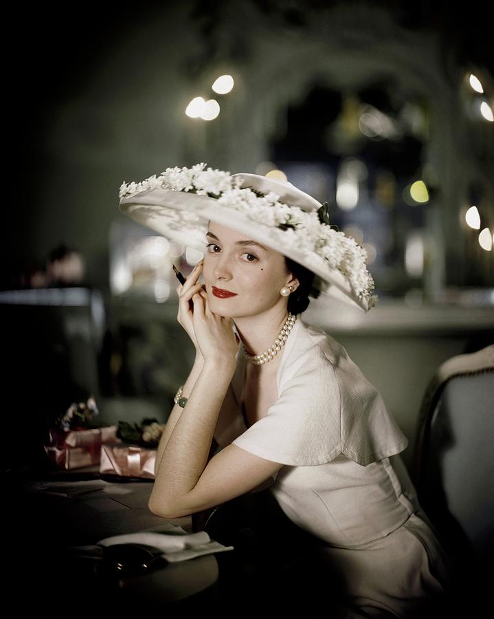 Model Sitting At A Table Wearing A Hat Photograph by Frances McLaughlin-Gill