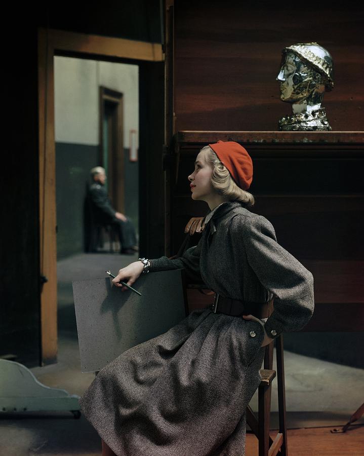 Model Sitting In A Tweed Dress And Red Hat Photograph by Frances McLaughlin-Gill