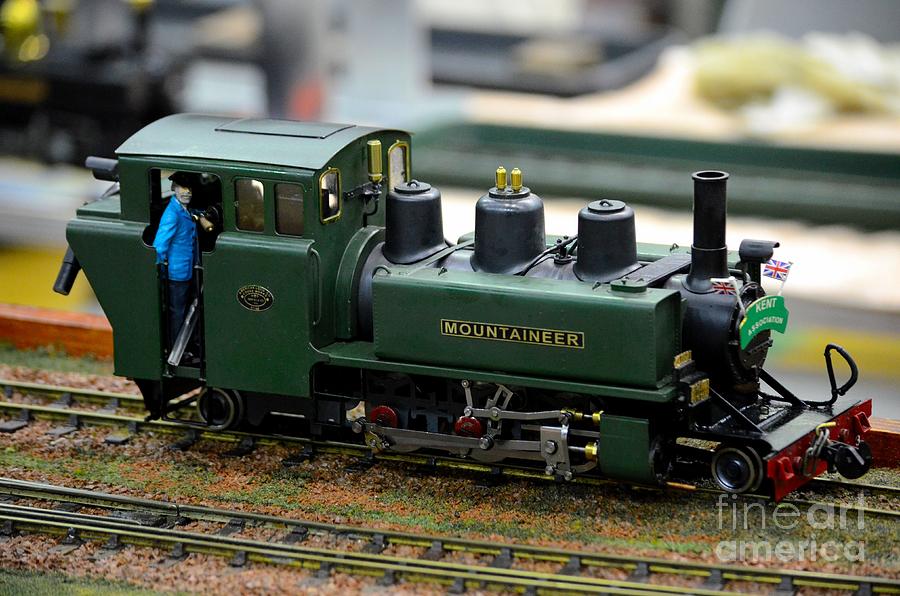 Model train green steam railway engine with driver in cab Photograph by Imran Ahmed