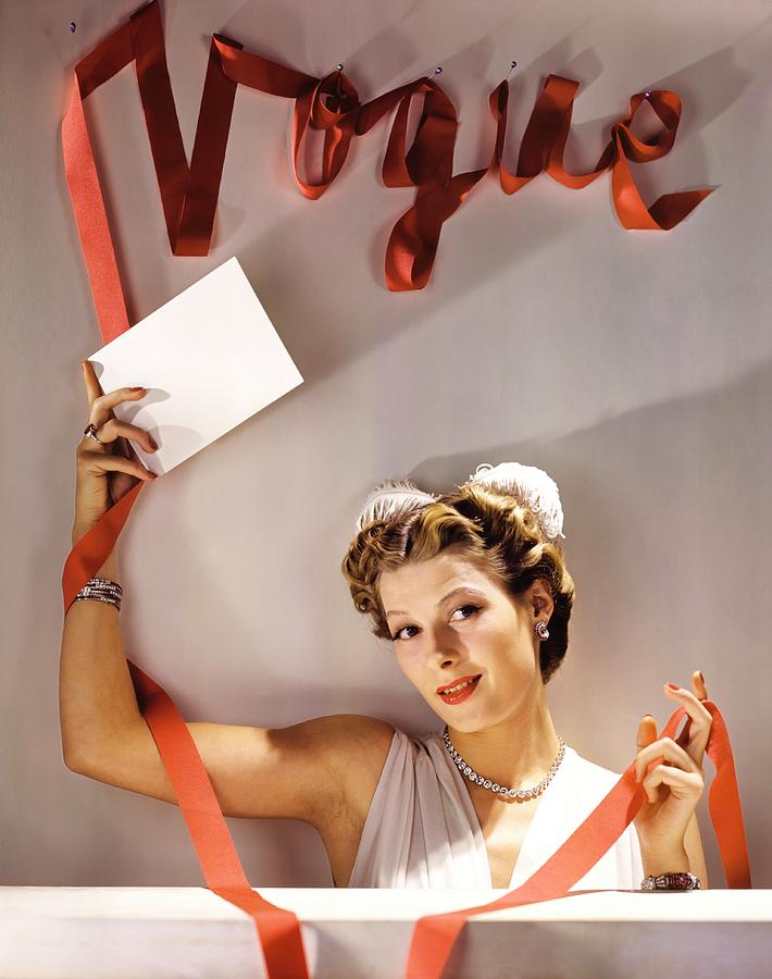 Model Wearing Jewellery Under A Vogue Sign Photograph by John Rawlings