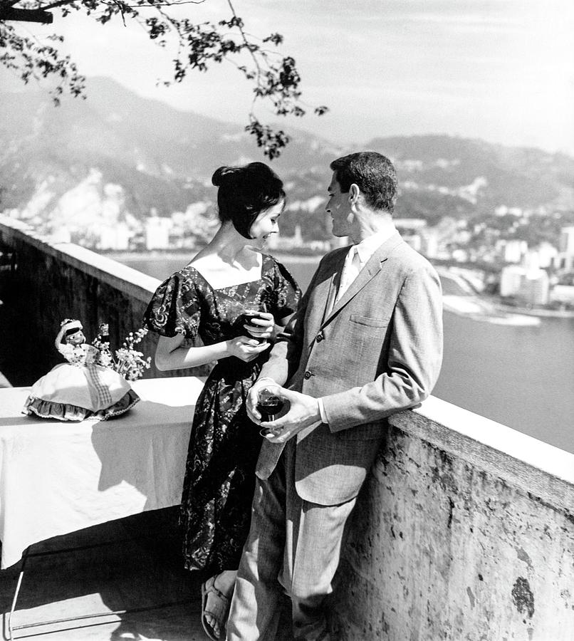 Models Holding Wine On A Balcony Photograph by Richard Waite