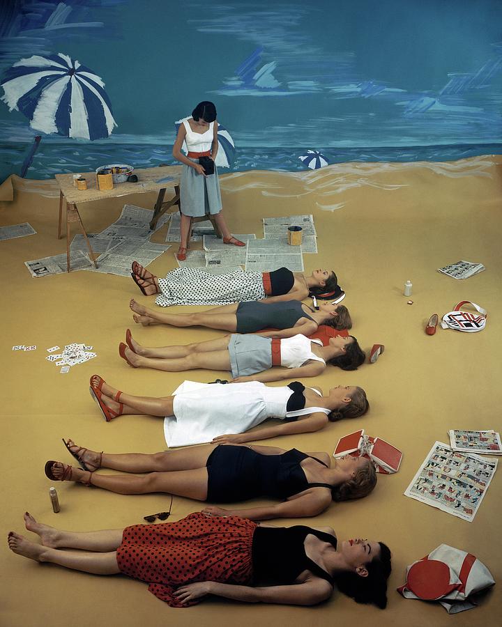 Models Lying On A Fake Beach Set At A Studio Photograph by Serge Balkin