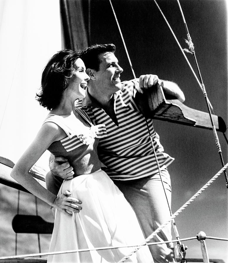 Models On A Sailboat Photograph by Richard Waite