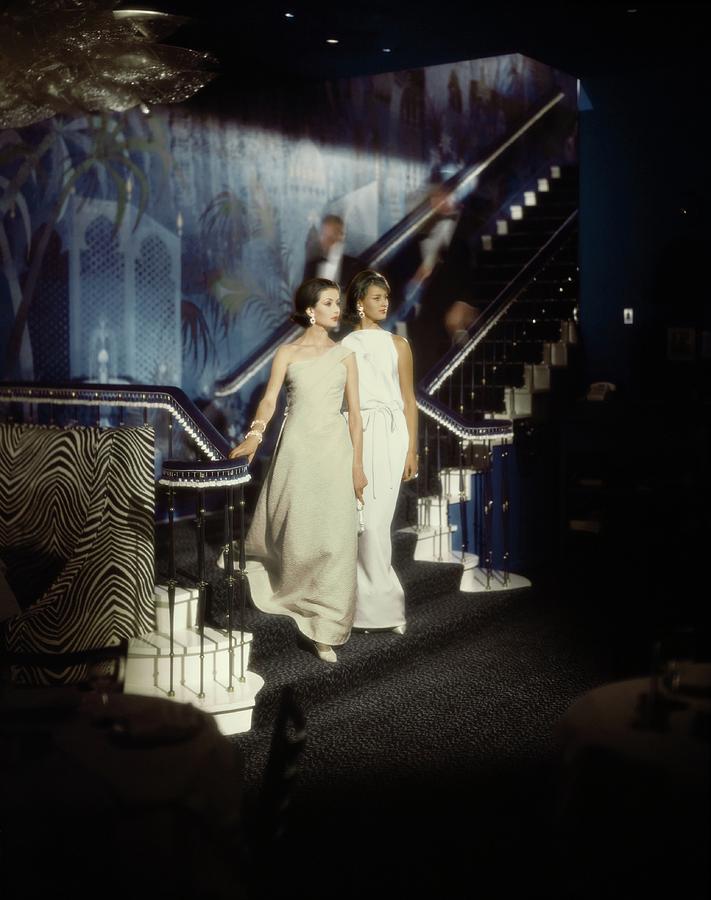Models Wearing Evening Gowns On A Staircase Photograph by John Rawlings