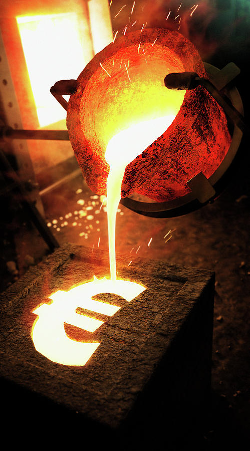 Molten Metal Pouring Into Euro Sign Mold Photograph by Ikon Ikon Images