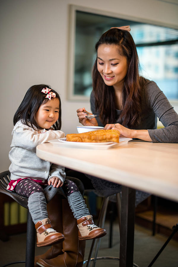 Mom & toddler girl having chinese breakfast Photograph by images by Tang Ming Tung
