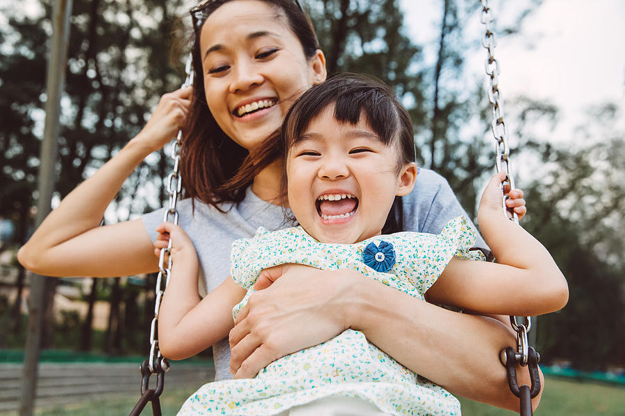 Mom & toddler swinging on swing joyfully in park Photograph by Images By Tang Ming Tung