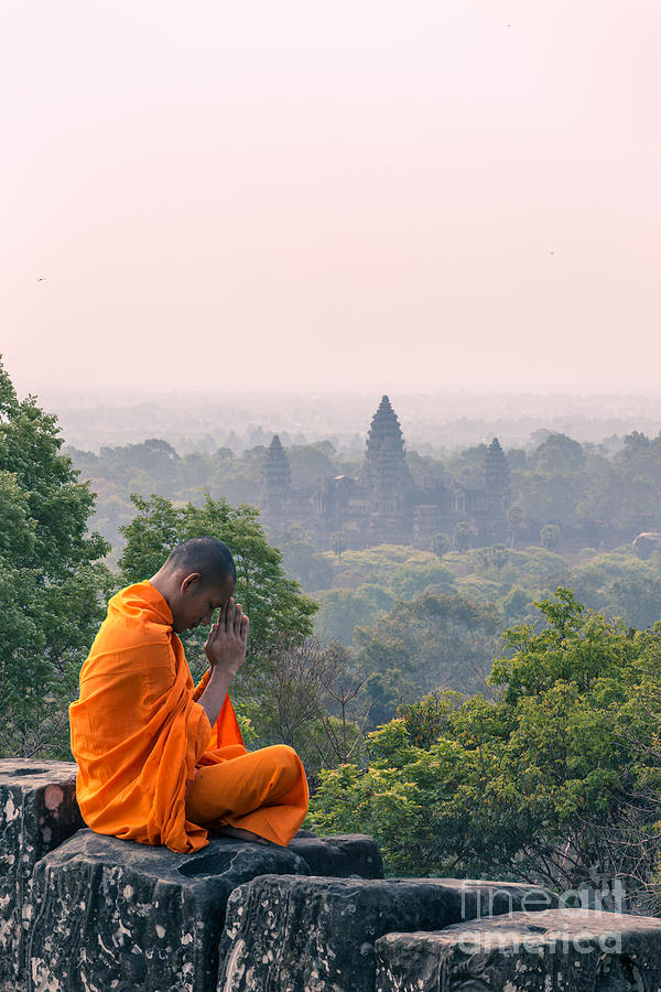 Monk praying in front of Angkor Wat temples - Cambodia Photograph by Matteo Colombo
