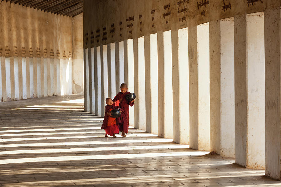 Monks In Walkway To Shwezigon Pagoda Photograph by Peter Adams